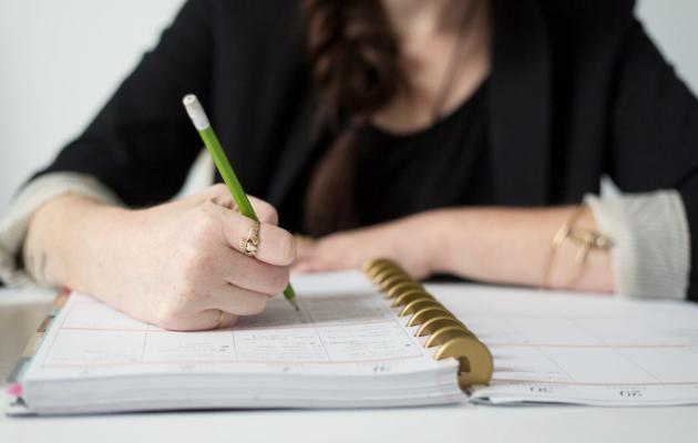 Photo of someone writing in a notebook