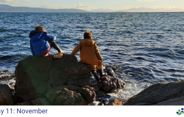 Image of two children playing on a rocky shore