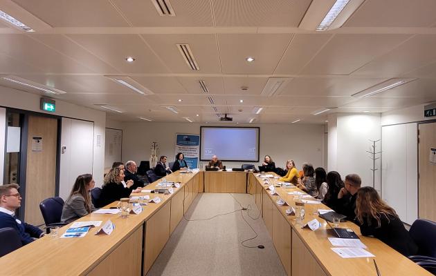 Image of people talking in a room in Brussels
